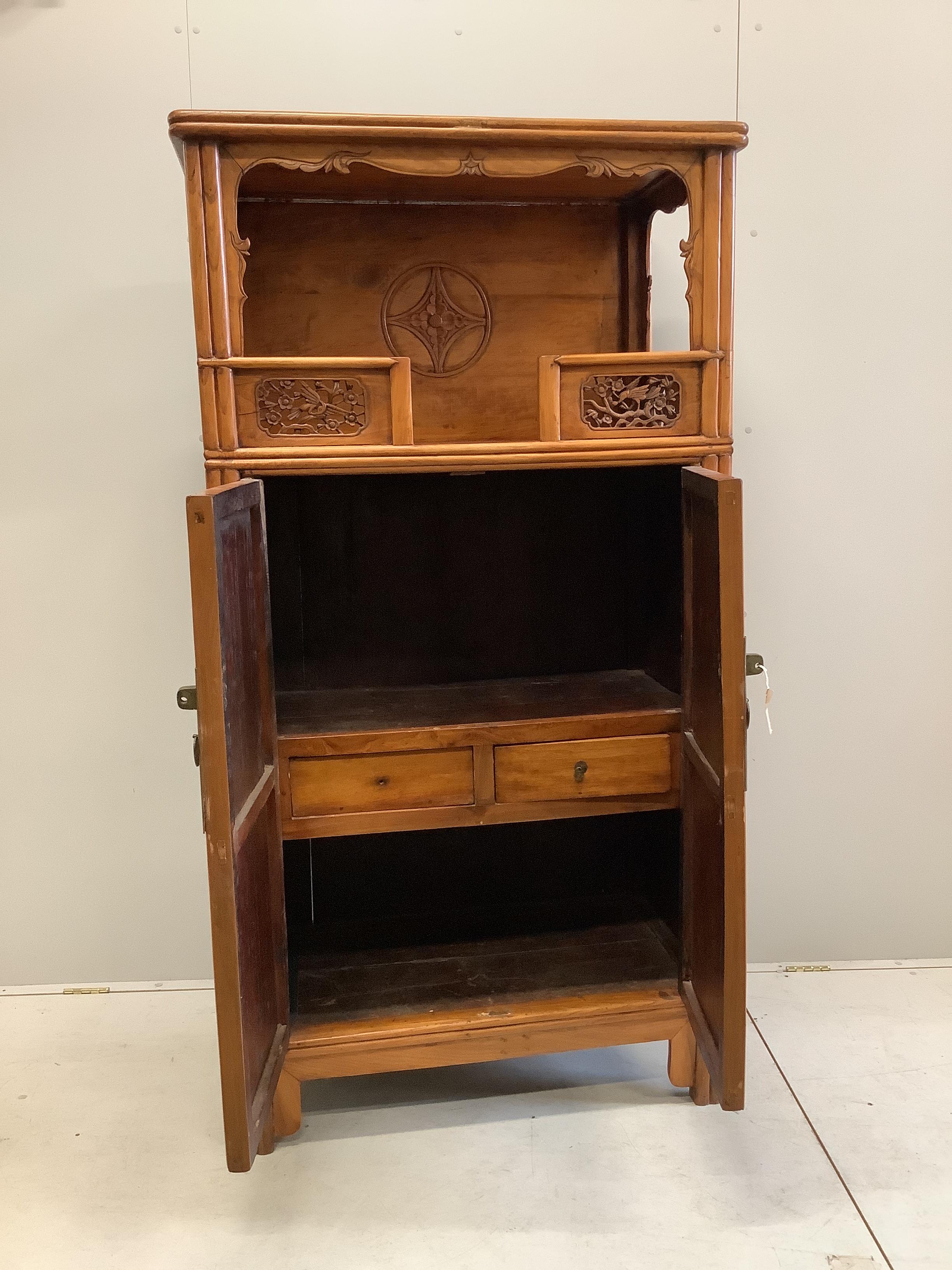 A Chinese carved elm cabinet, width 82cm, depth 55cm, height 182cm